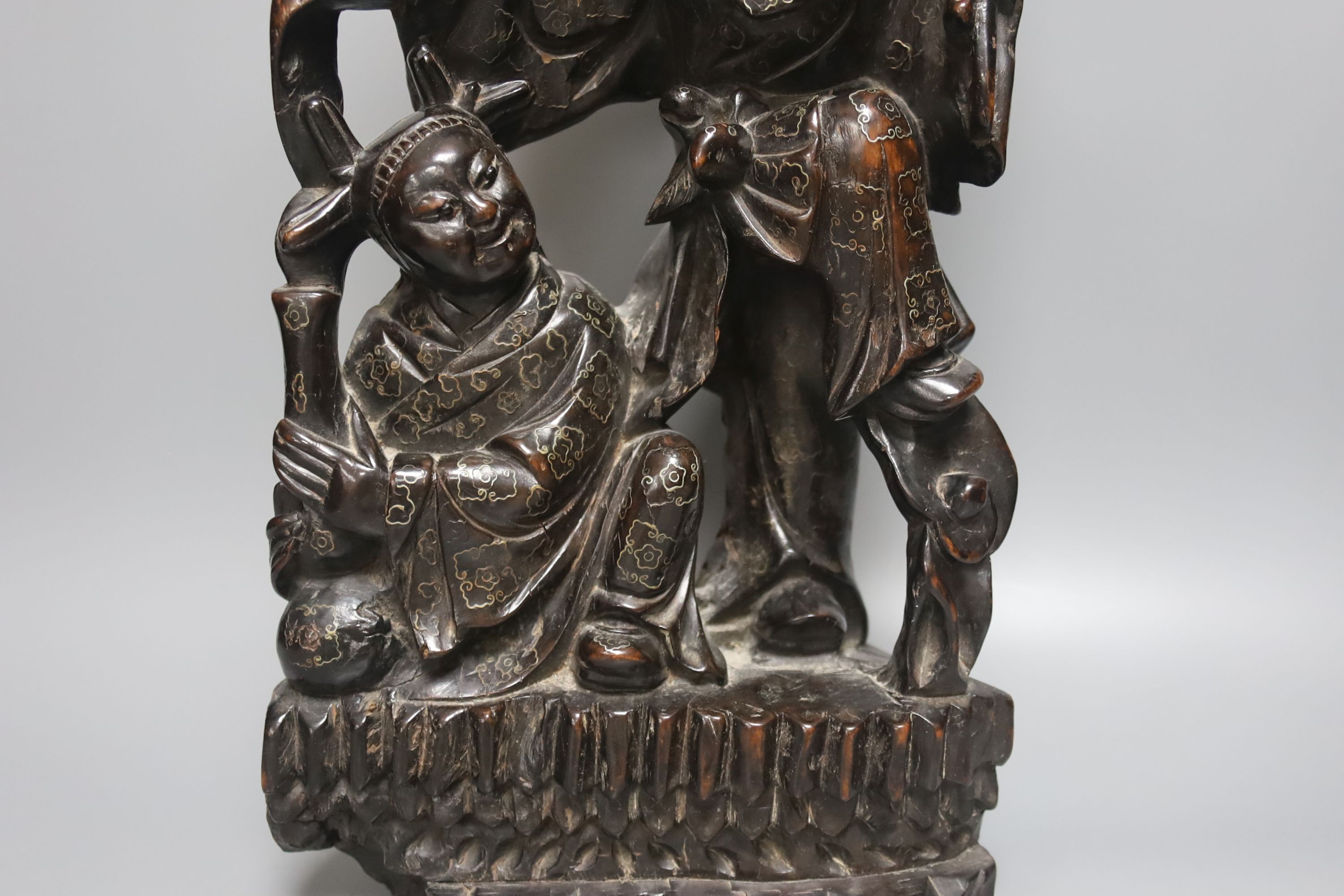 A Chinese hardwood and wire inlaid group of the He He Erxian and a similar figure of Budai, both early 20th century, tallest 49cm